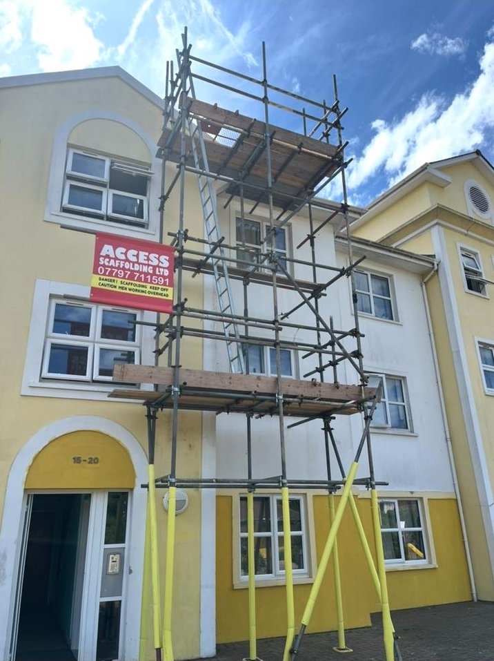 Access Scaffolding tower on a yellow apartment block in Jersey